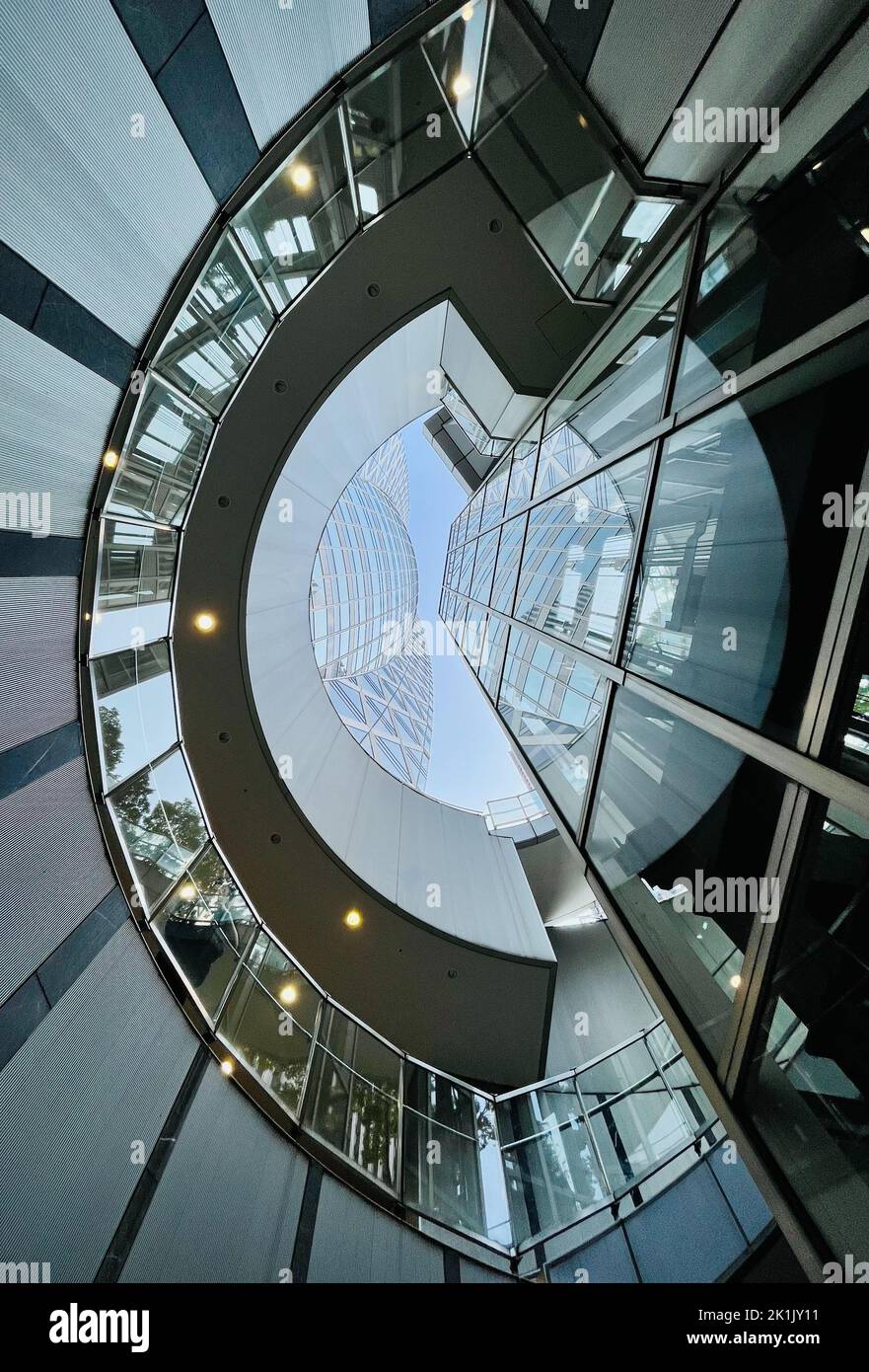A vertical shot of modern glass buildings from an under view in ...