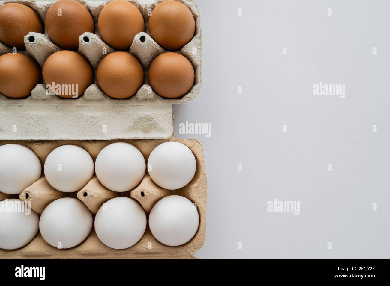 Top view of fresh chicken eggs in boxes on white background Stock Photo ...