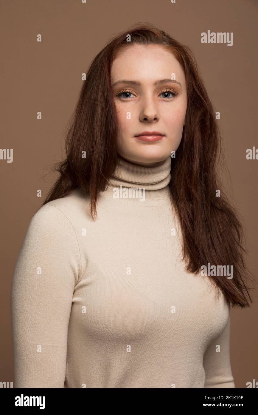 Portrait of serious redhead teenage girl in turtleneck Stock Photo