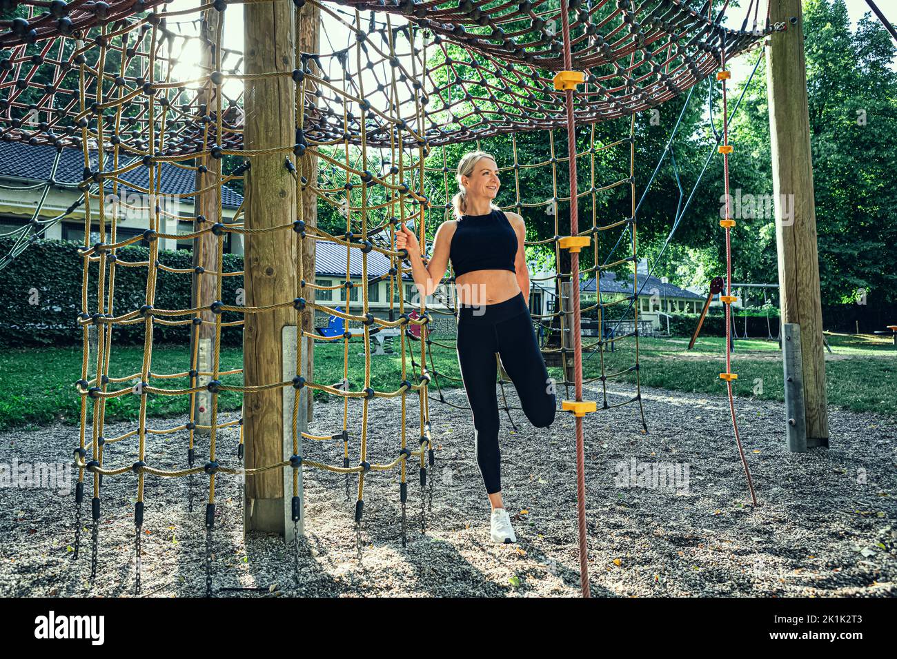 young woman at physical activities or workout on a fitness path in the park Stock Photo