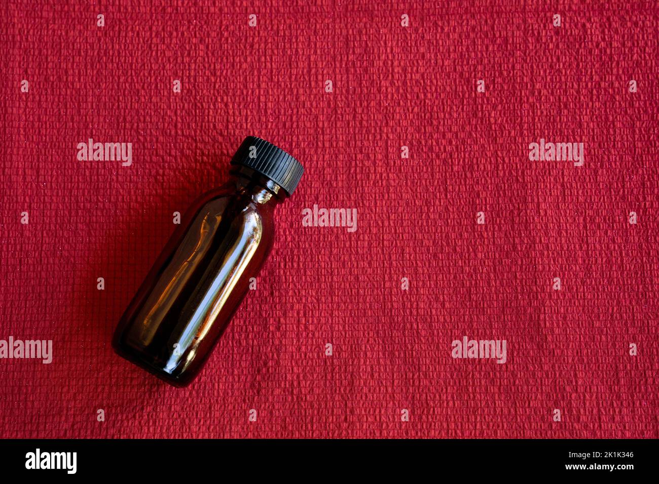 Mock-up amber glass bottle on red background Stock Photo - Alamy