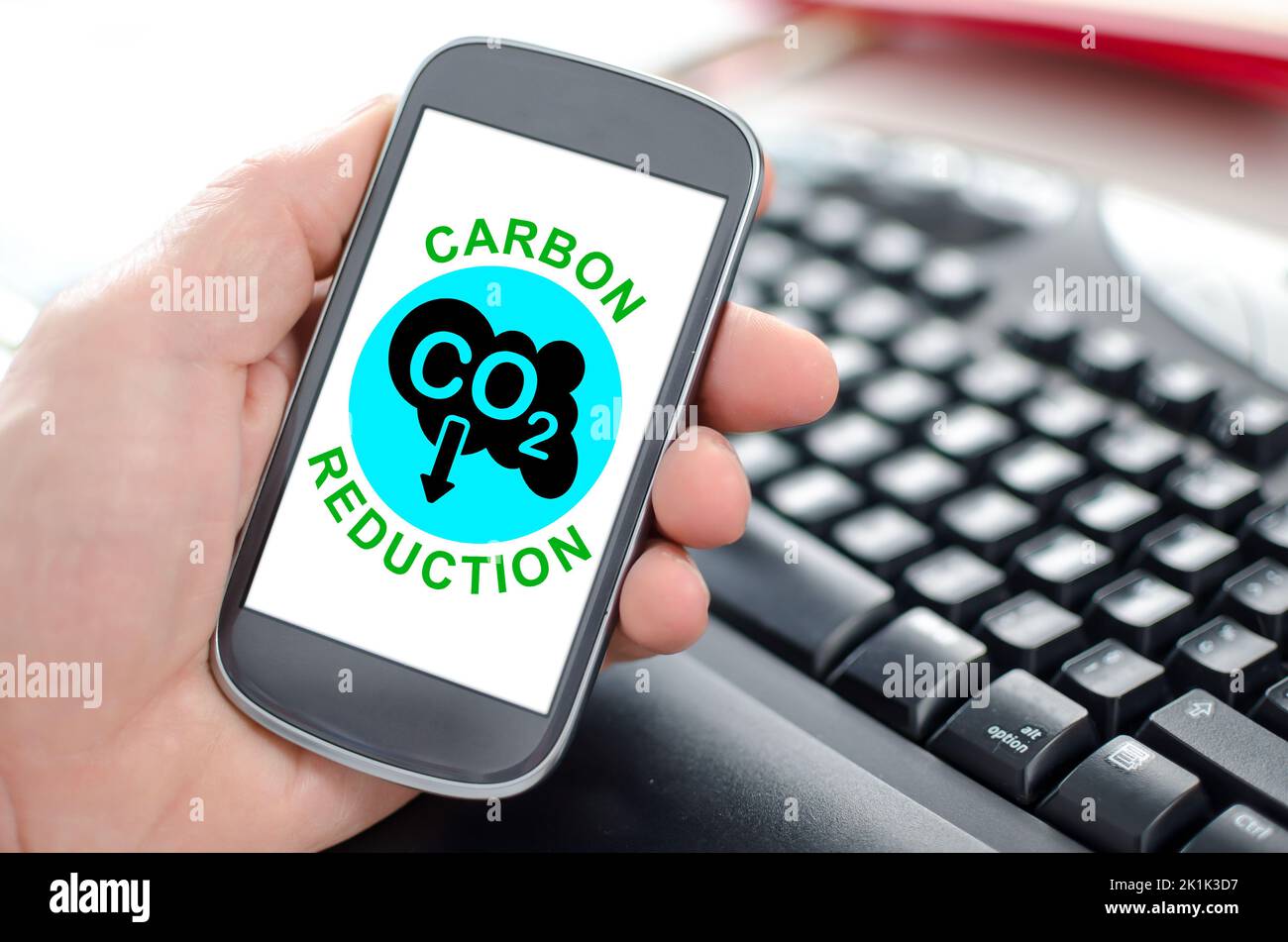 premium photo | co2 reducing icon using smartphone for... Hand holding a smartphone showing a carbon reduction concept Stock ...