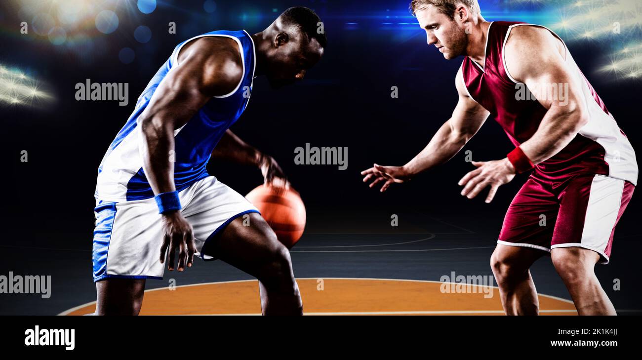 Basketball players in action against basketball court Stock Photo - Alamy