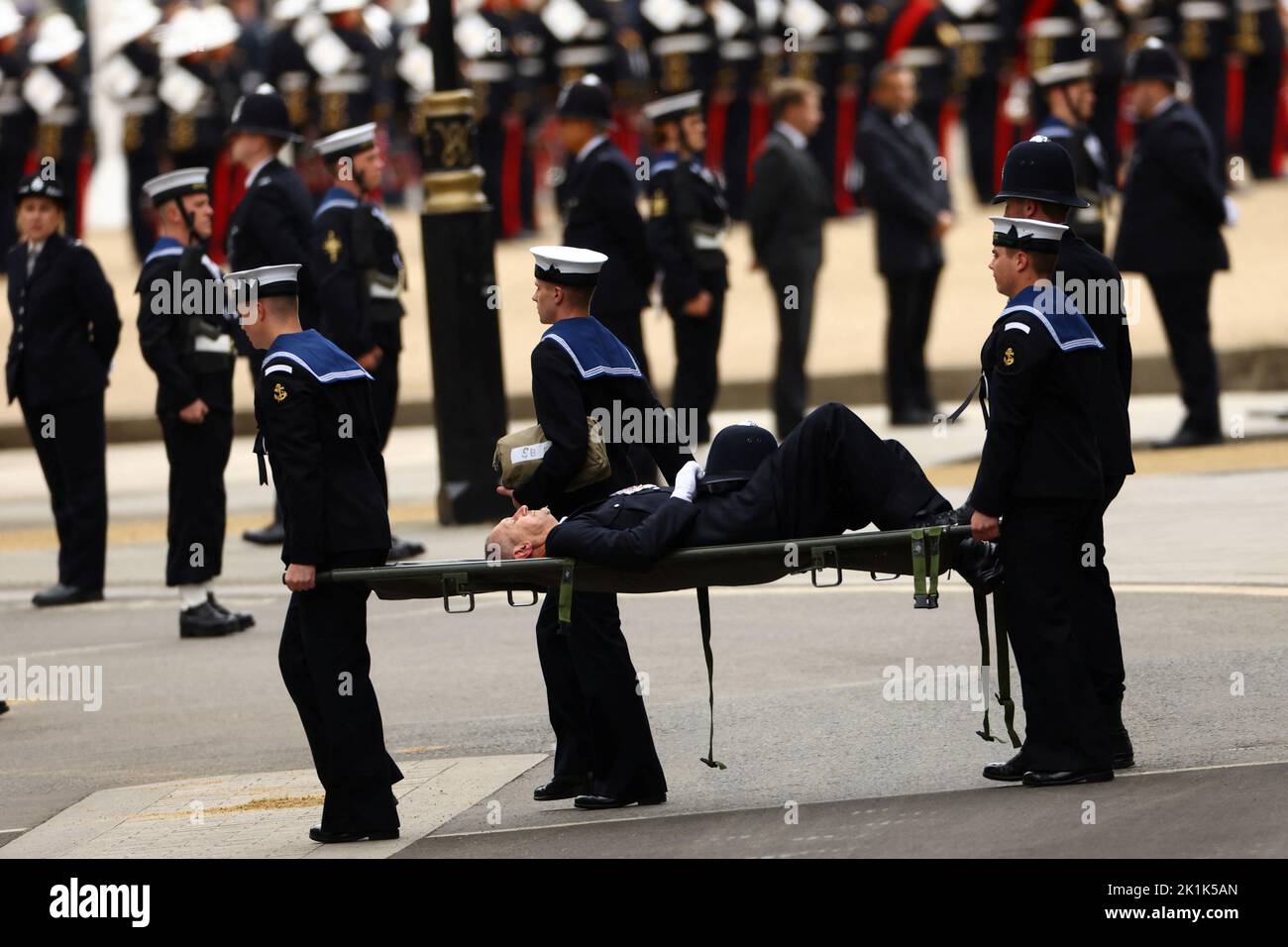 A policeman who collapsed being taken away outside Westminster Abbey on the day of the state funeral and burial of Britain's Queen Elizabeth, in London, Britain, September 19, 2022.  REUTERS/Kai Pfaffenbach     TPX IMAGES OF THE DAY Stock Photo