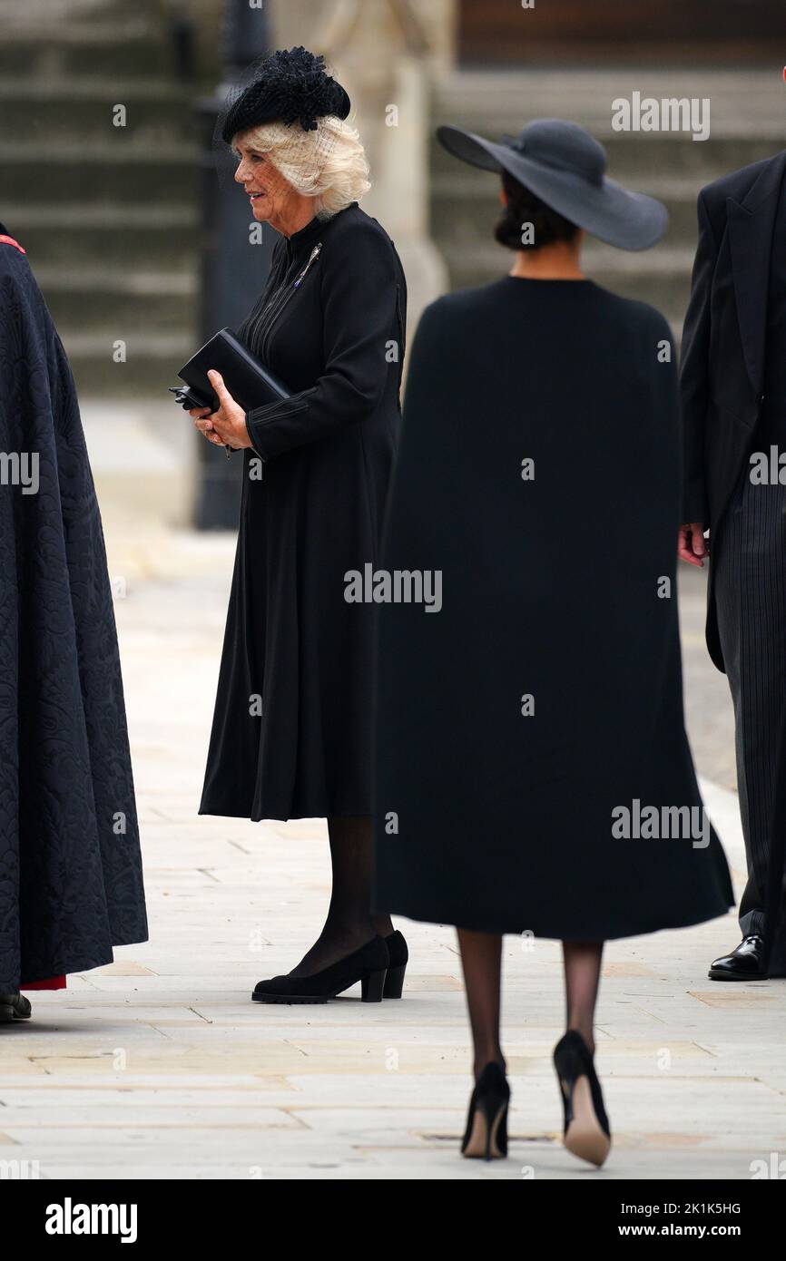 The Queen Consort and the Duchess of Sussex (right) arriving at the State Funeral of Queen Elizabeth II, held at Westminster Abbey, London. Picture date: Monday September 19, 2022. Stock Photo
