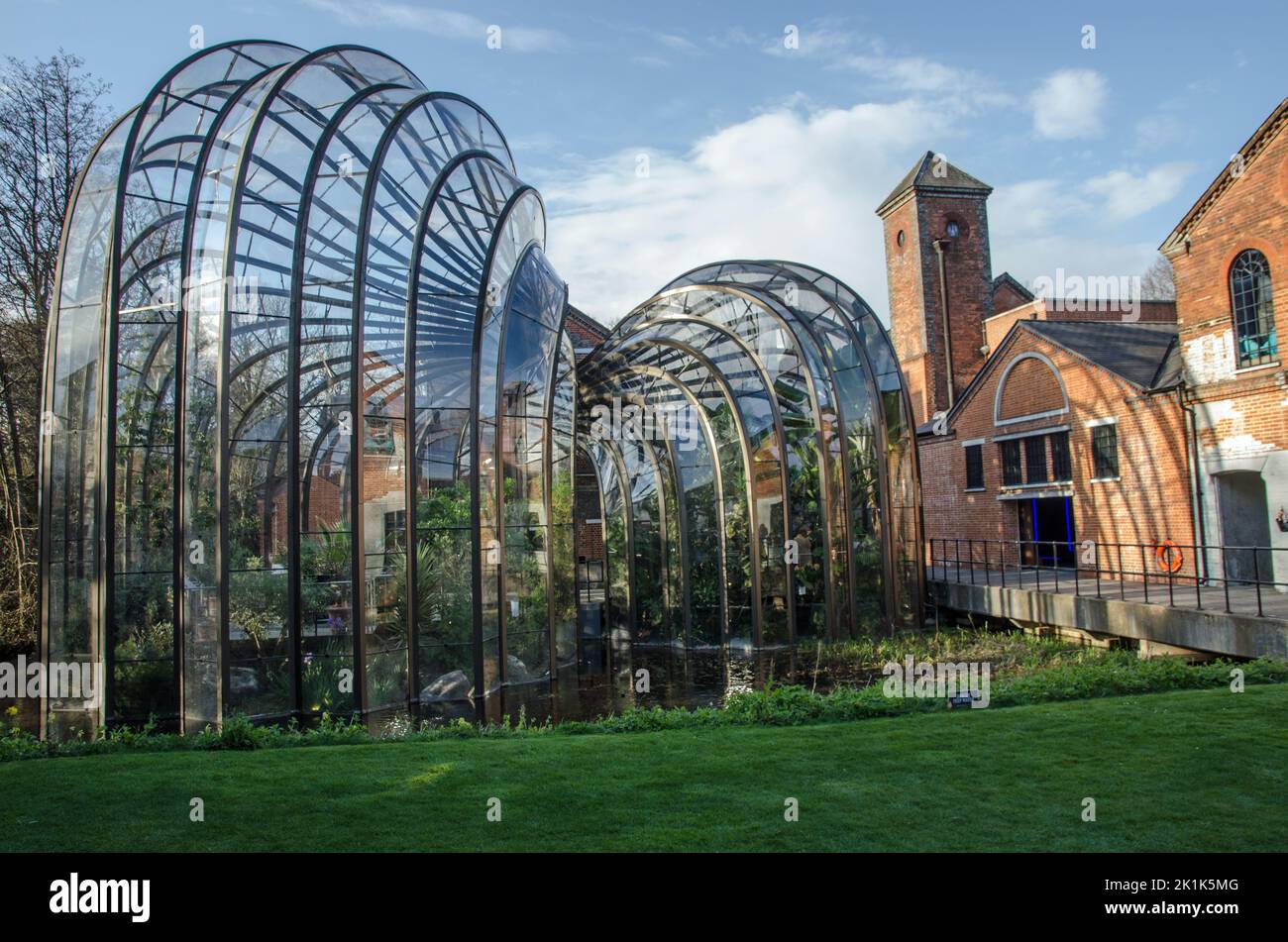 The elegant glass and bronze greenhouse designed by Thomas Hetherwick as part of the visitor experience at the Bombay Sapphire Gin Distillery at Laver Stock Photo