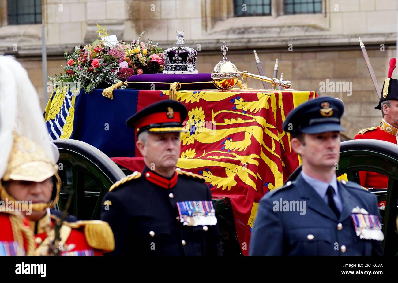 The State Gun Carriage carries the coffin of Queen Elizabeth II, draped in the Royal Standard with the Imperial State Crown and the Sovereign's orb and sceptre, as it leaves Westminster Hall for the State Funeral at Westminster Abbey, London. Picture date: Monday September 19, 2022. Stock Photo