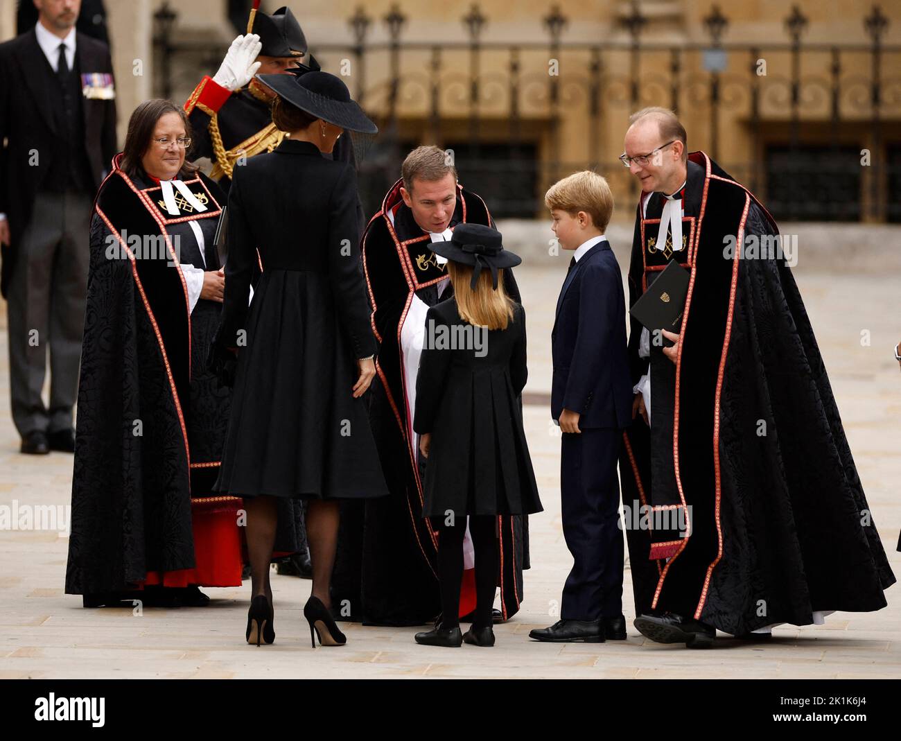 Britain's Catherine, Princess of Wales, Britain's Princess Charlotte and Britain's Prince George are greeted by The Reverend Jamie Hawkey, The Right Reverend Anthony Ball and The Venerable Patricia Hillas outside Westminster Abbey on the day of state funeral and burial of Britain's Queen Elizabeth, in London, Britain, September 19, 2022 REUTERS/John Sibley Stock Photo