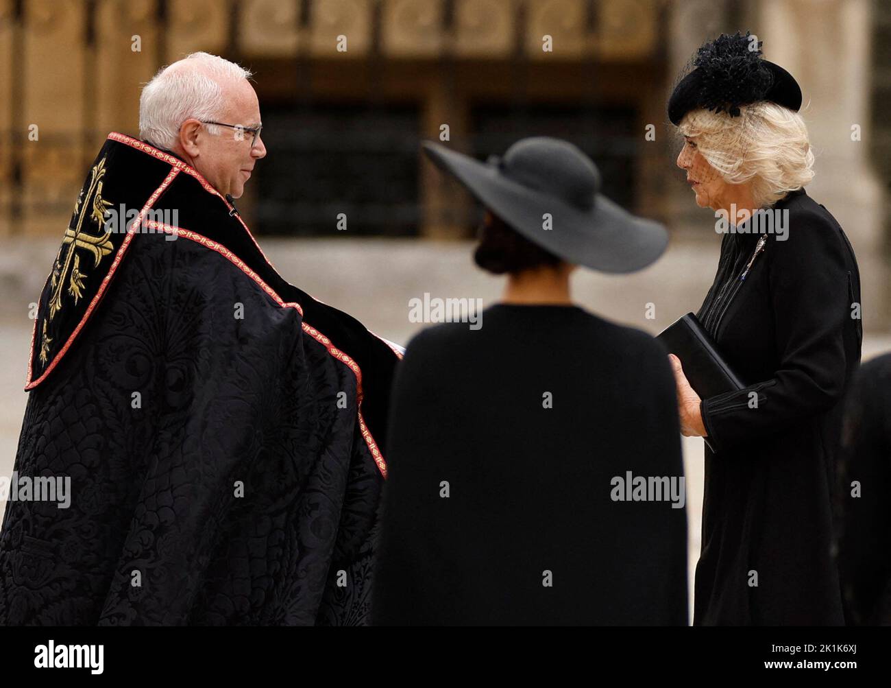 Dean of Westminster David Hoyle greets Queen Camilla as she arrives at Westminster Abbey on the day of state funeral and burial of Britain's Queen Elizabeth, in London, Britain, September 19, 2022 REUTERS/John Sibley Stock Photo