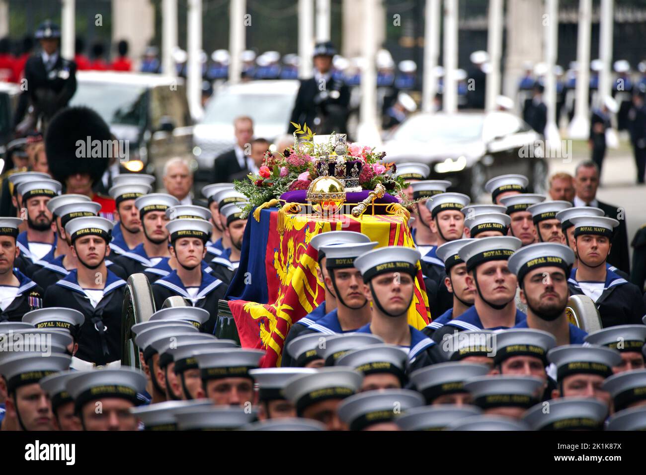 The State Gun Carriage carries the coffin of Queen Elizabeth II, draped in the Royal Standard with the Imperial State Crown and the Sovereign's orb and sceptre, in the Ceremonial Procession during her State Funeral at Westminster Abbey, London. Picture date: Monday September 19, 2022. Stock Photo