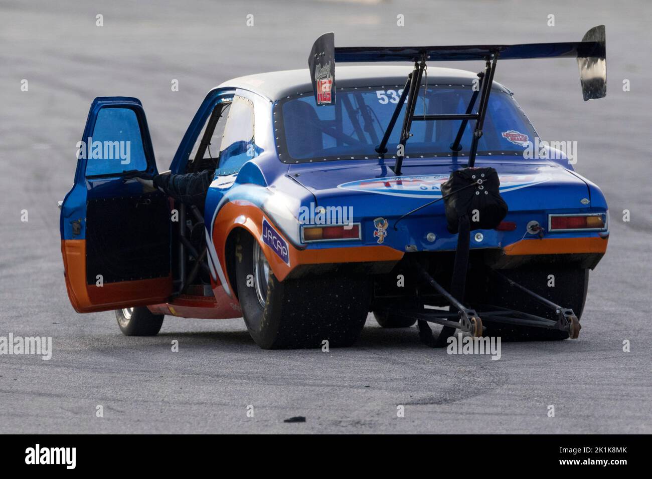 Heavily modified Ford Escort Mk I used as dragsters doing some practice runs at the EX-RAF airfield runway. Stock Photo