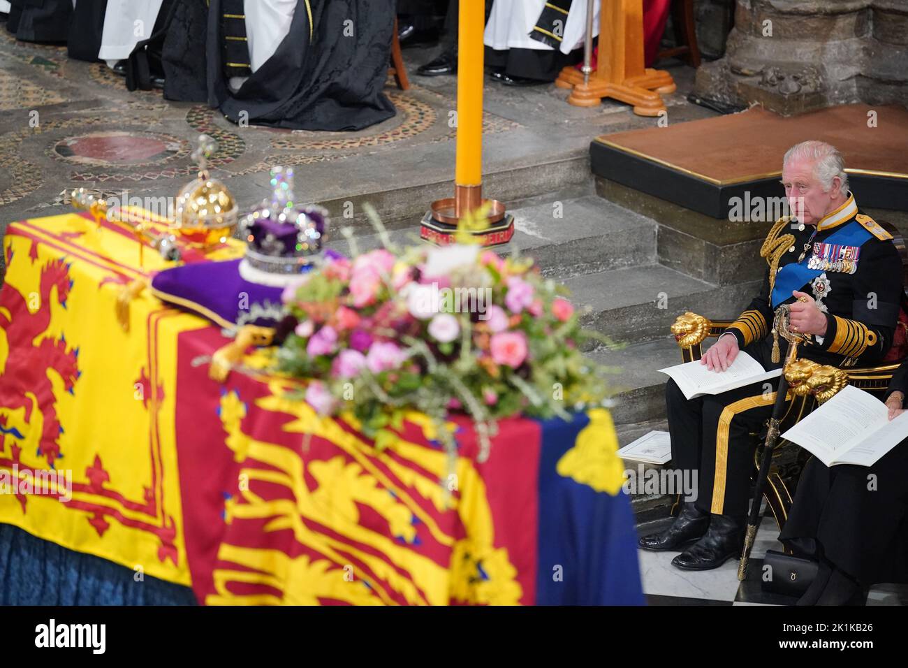 King Charles III in front of the coffin of Queen Elizabeth II during her State Funeral at the Abbey in London. Picture date: Monday September 19, 2022. Stock Photo