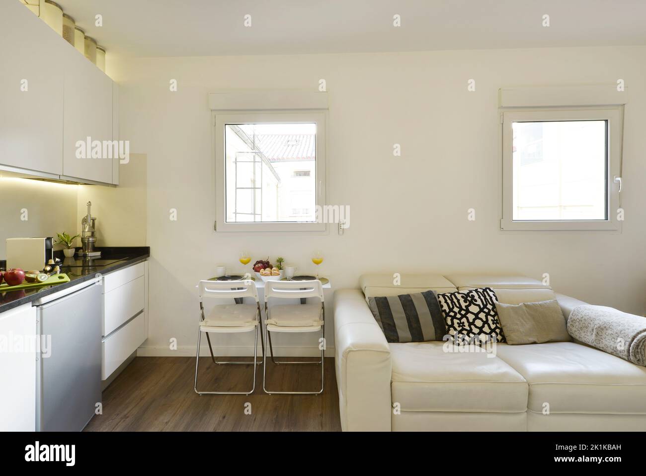 Studio apartment with open kitchen, folding table with fruit bowl and ...
