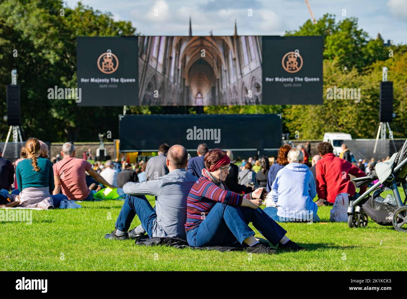 Edinburgh, Scotland, UK. 19th September 2022. Members of the public gather in Holyrood Park to watch live screening on big screen of funeral of Queen Elizabeth II from Westminster Abbey.   Iain Masterton/Alamy Live News Stock Photo
