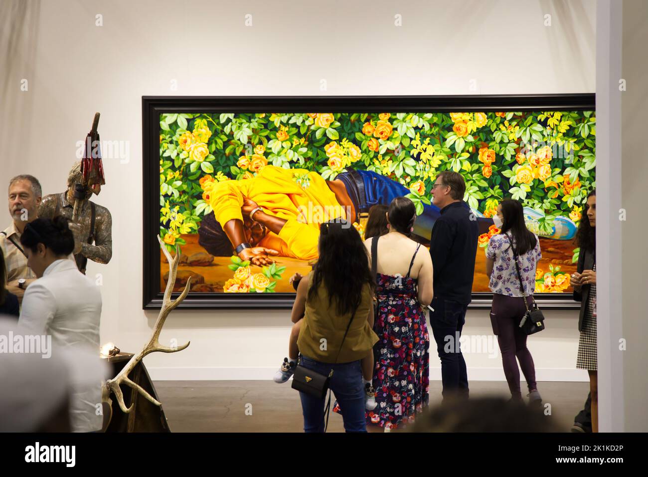 A group of people observing paintings in the Armory show New York Art