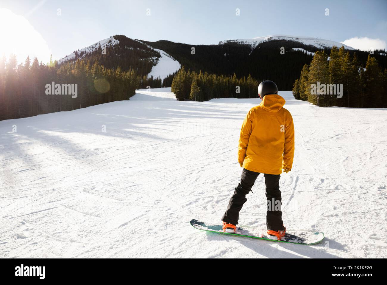 Male snowboarder on sunny snowy mountain ski slope Stock Photo