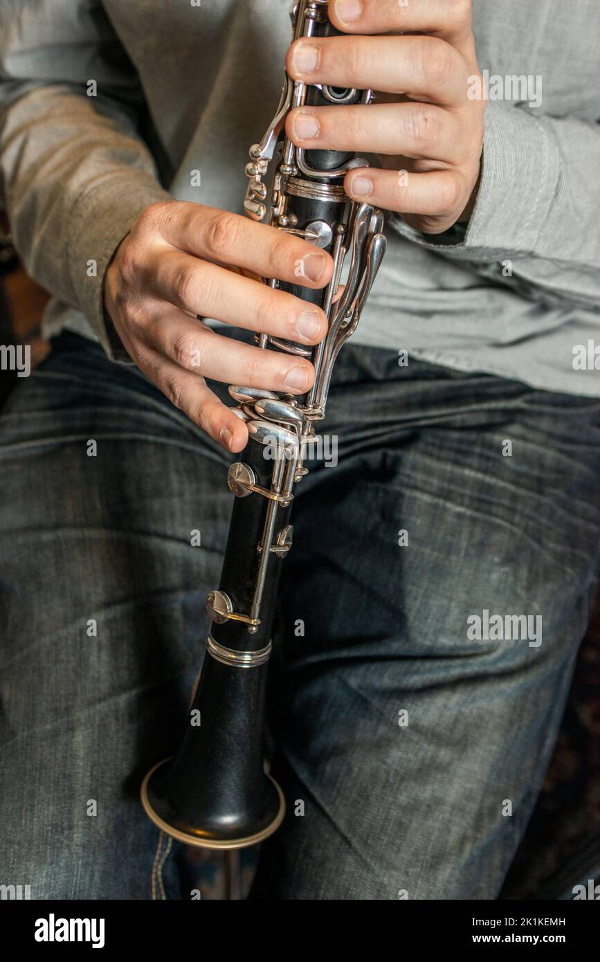 Hands of a musician preparing to play the clarinet Stock Photo