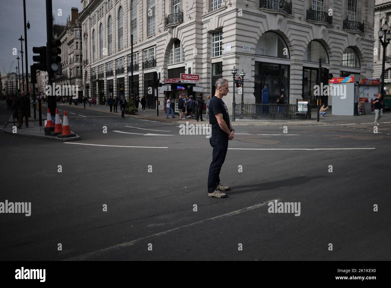 A man stands during the moment of silence on the day of the state funeral and burial of Britain's Queen Elizabeth, in London, Britain, September 19, 2022. REUTERS/Carlos Barria Stock Photo