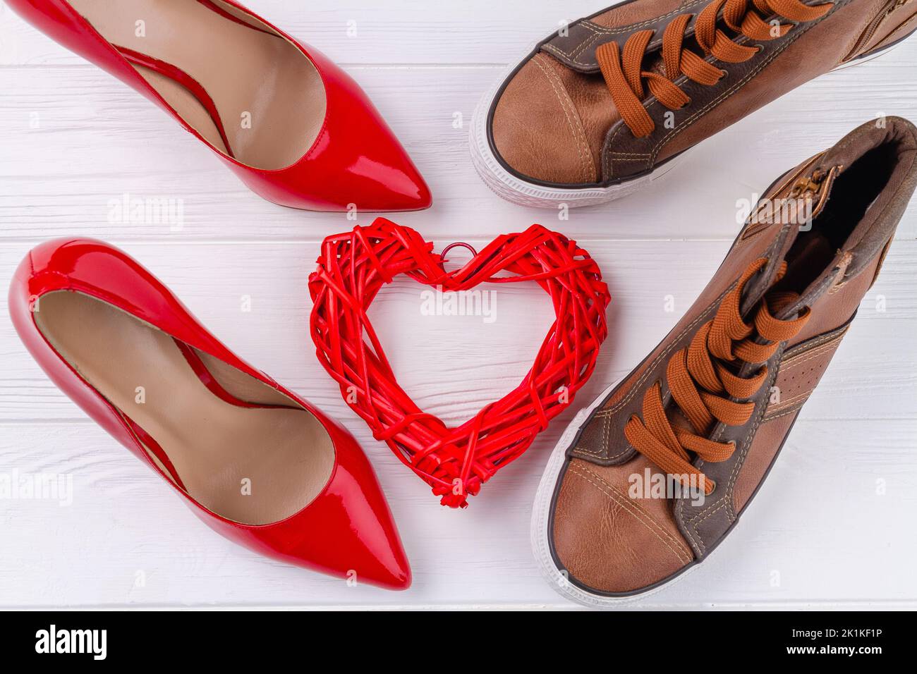 Top view of mens and womens shoes on white desk. Love or marriage concept. Stock Photo