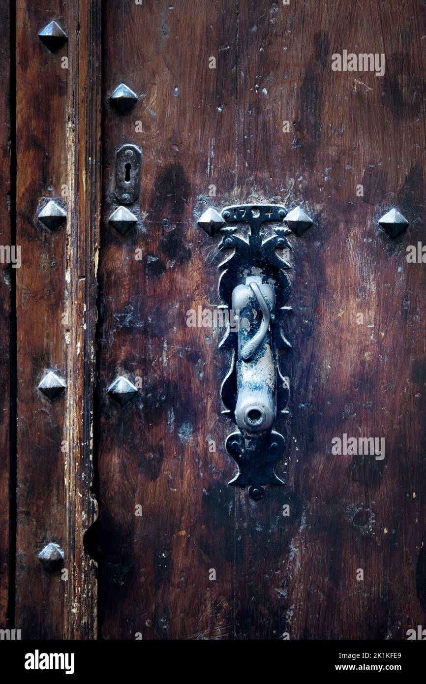 Weathered Beast Handle on Old Door Stock Photo