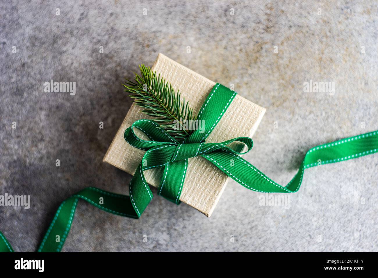 Overhead view of a rustic gift box tied with a ribbon and decorated ...