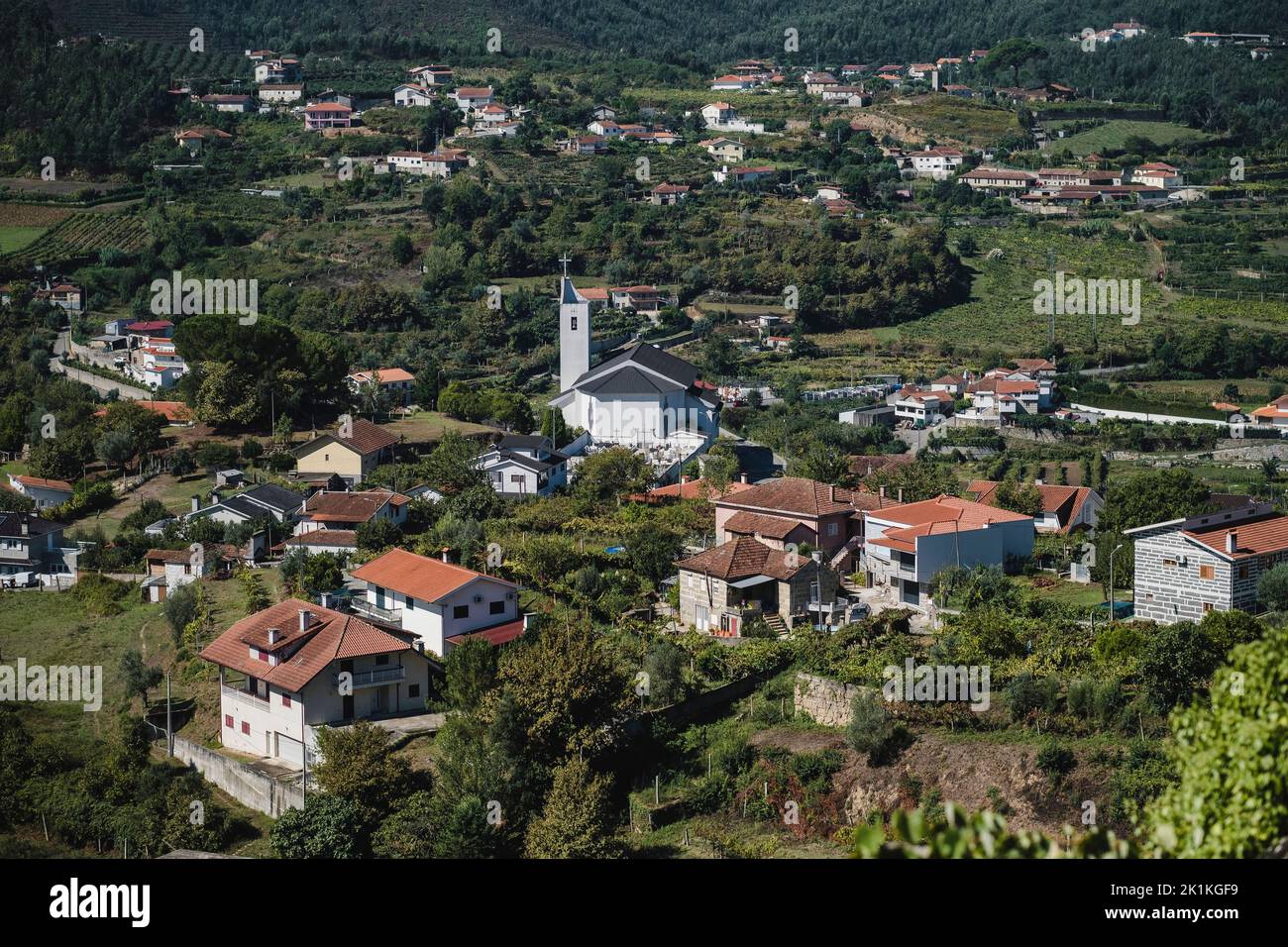 View of residential houses and a church in the hills of the Douro Valley, Porto, Portugal. Stock Photo