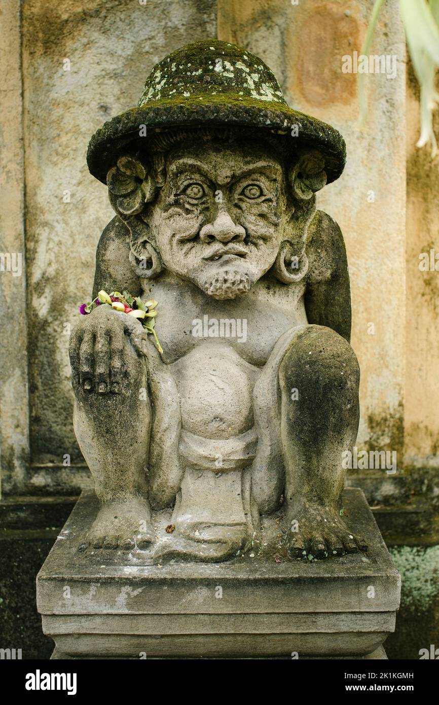 Traditional guard statue in the street carved from stone in Bali, Indonesia. Stock Photo