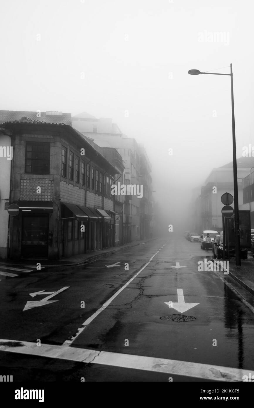 View of the buildings on foggy street, Porto, Portugal. Black and white photo. Stock Photo