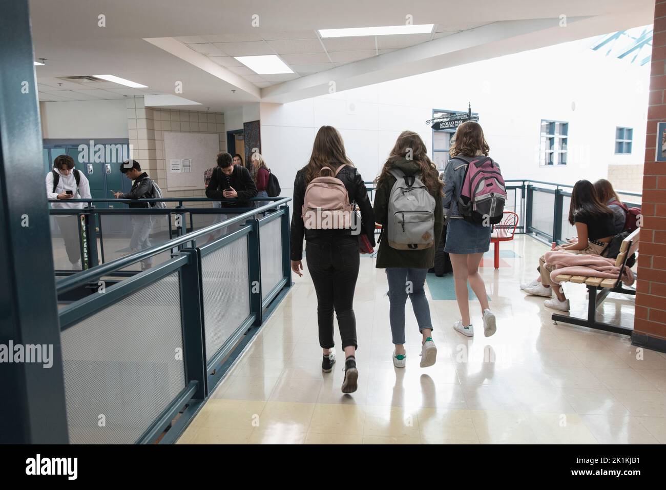 High school girl students with backpacks walking in corridor Stock Photo Alamy