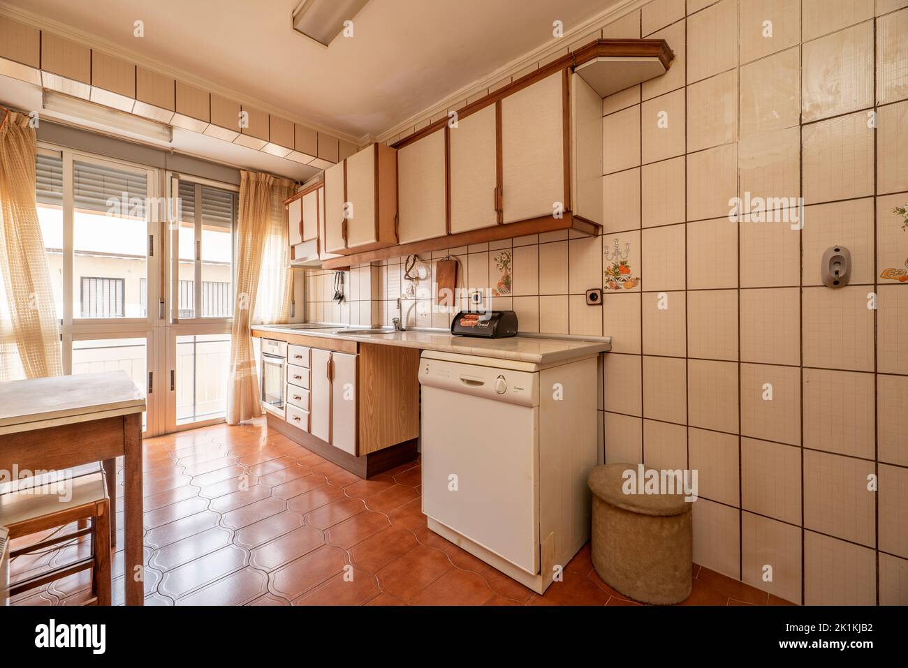 Antique kitchen with edge wood folding table with stools, bay