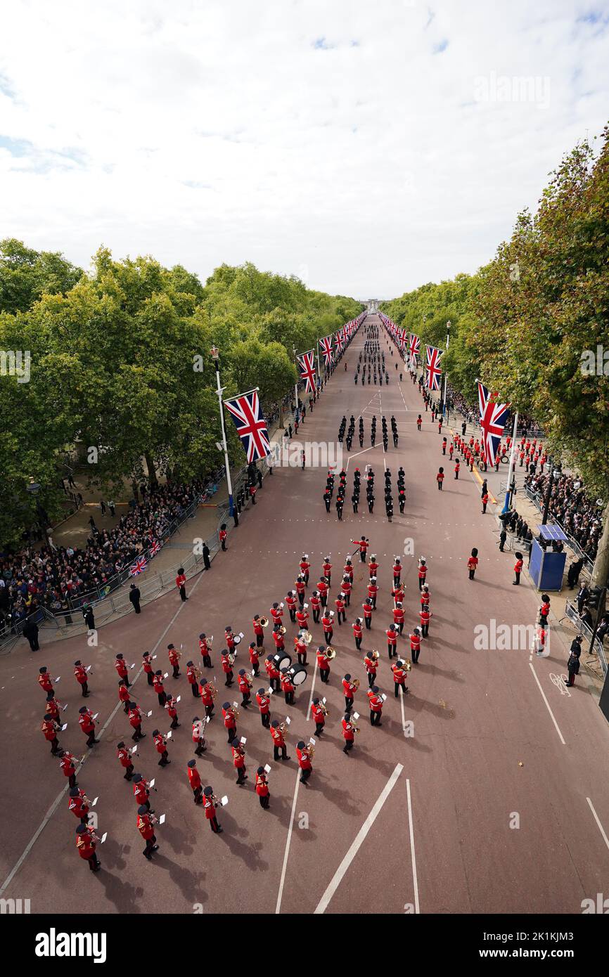 Members of a military marching band march down The Mall in central