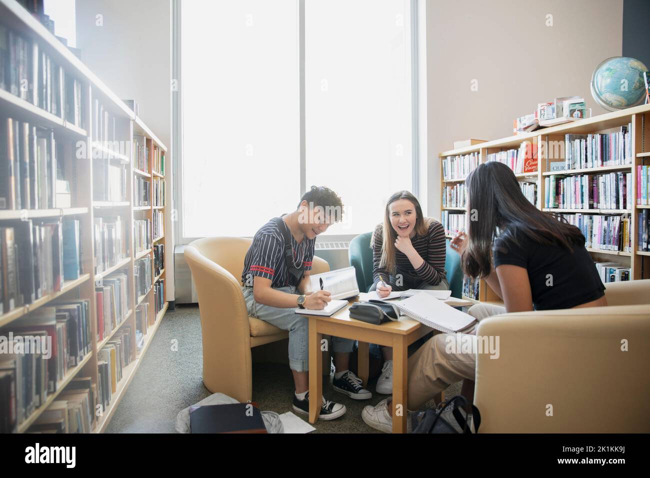High School Students Talking And Studying In Library Stock Photo Alamy