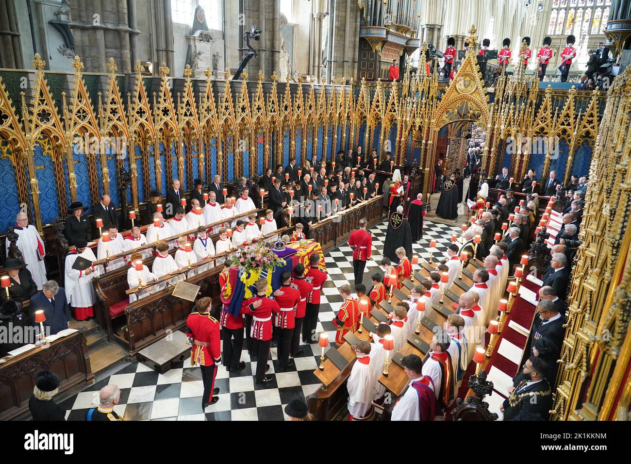 The coffin of Queen Elizabeth II, draped in the Royal Standard with the Imperial State Crown and the Sovereign's Orb and Sceptre, is carried from her State Funeral at Westminster Abbey in London. Picture date: Monday September 19, 2022. Stock Photo