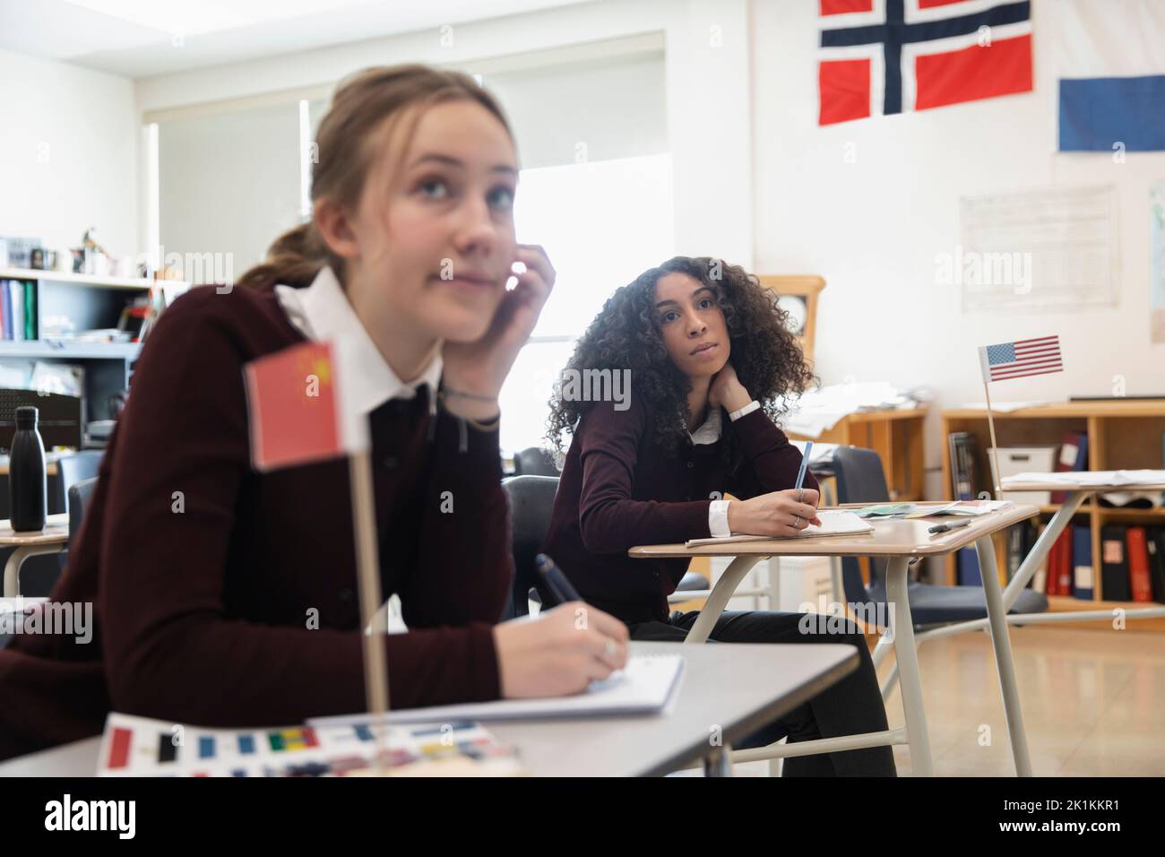 Focused high school girls listening in geography class Stock Photo Alamy