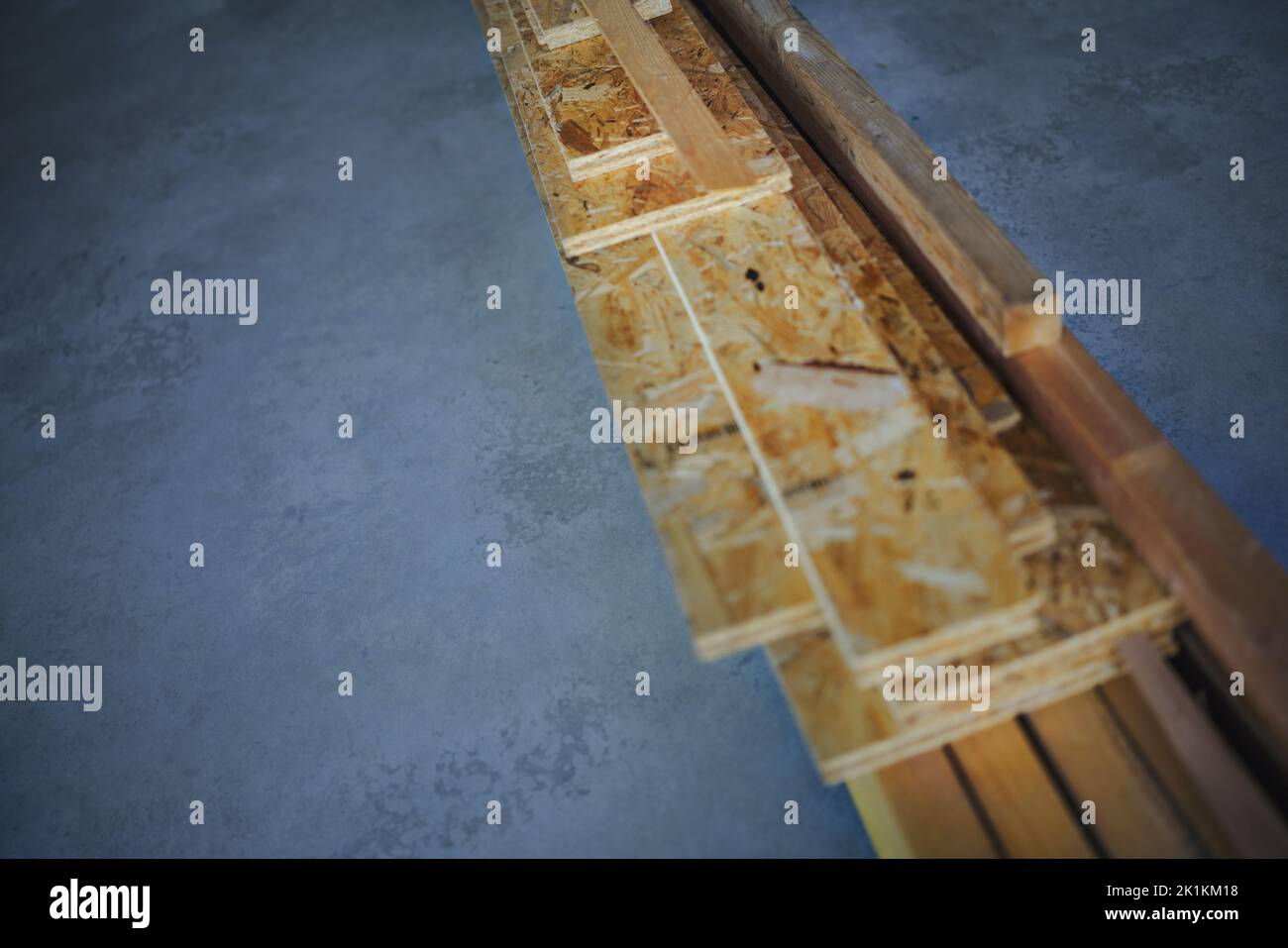 Top view of construction wooden boards at concrete floor, concept of eco house, healthy living