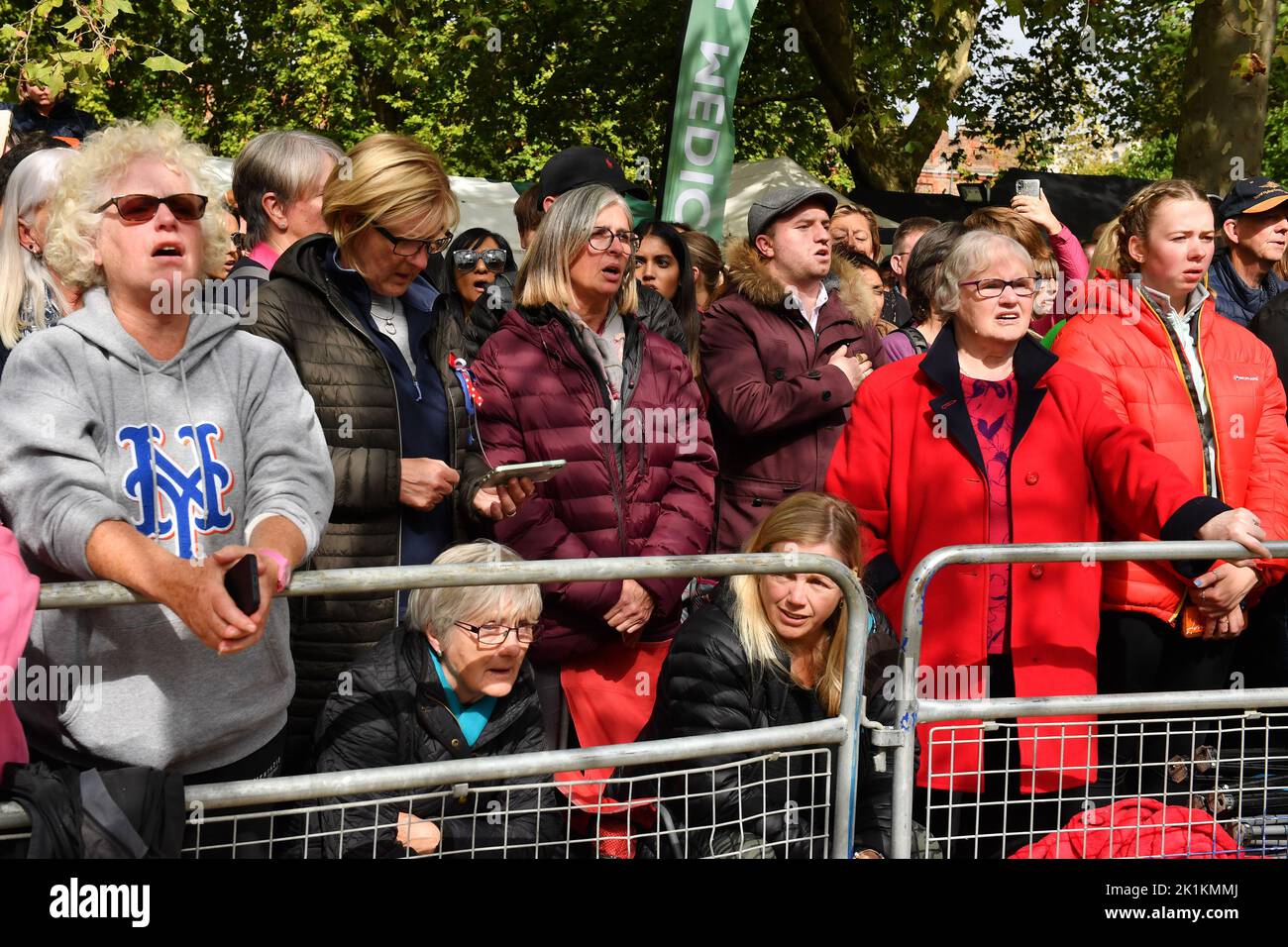 Members of the public in the crowd on The Mall, central London wait for the coffin procession after the State Funeral of Queen Elizabeth II. Picture date: Monday September 19, 2022. Stock Photo