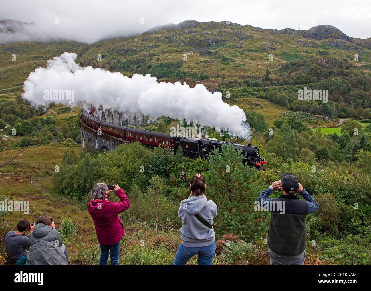 Glenfinnan, Scotland, UK, 19th September 2022. Floral tribute to Her Majesty Queen Elizabeth 11 displayed on front of Jacobite Steam Train engine as it is passes over the west highland line Glenfinnan Viaduct just before her funeral service at Westminster Abbey in London. Credit: Arch White/alamy live news. Stock Photo