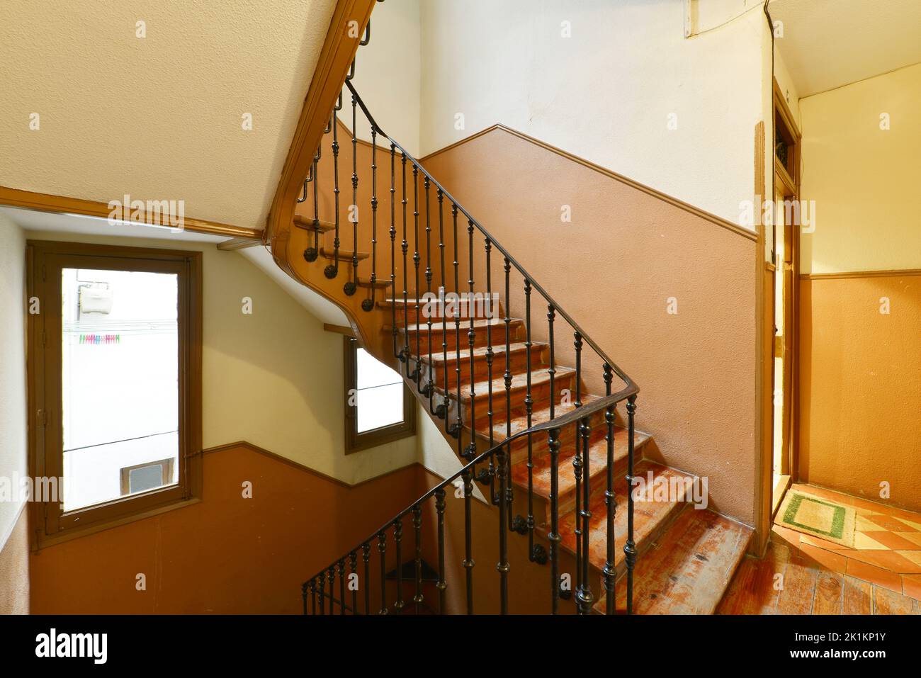 Weathered wooden stairs and black metal railing in a vintage building ...