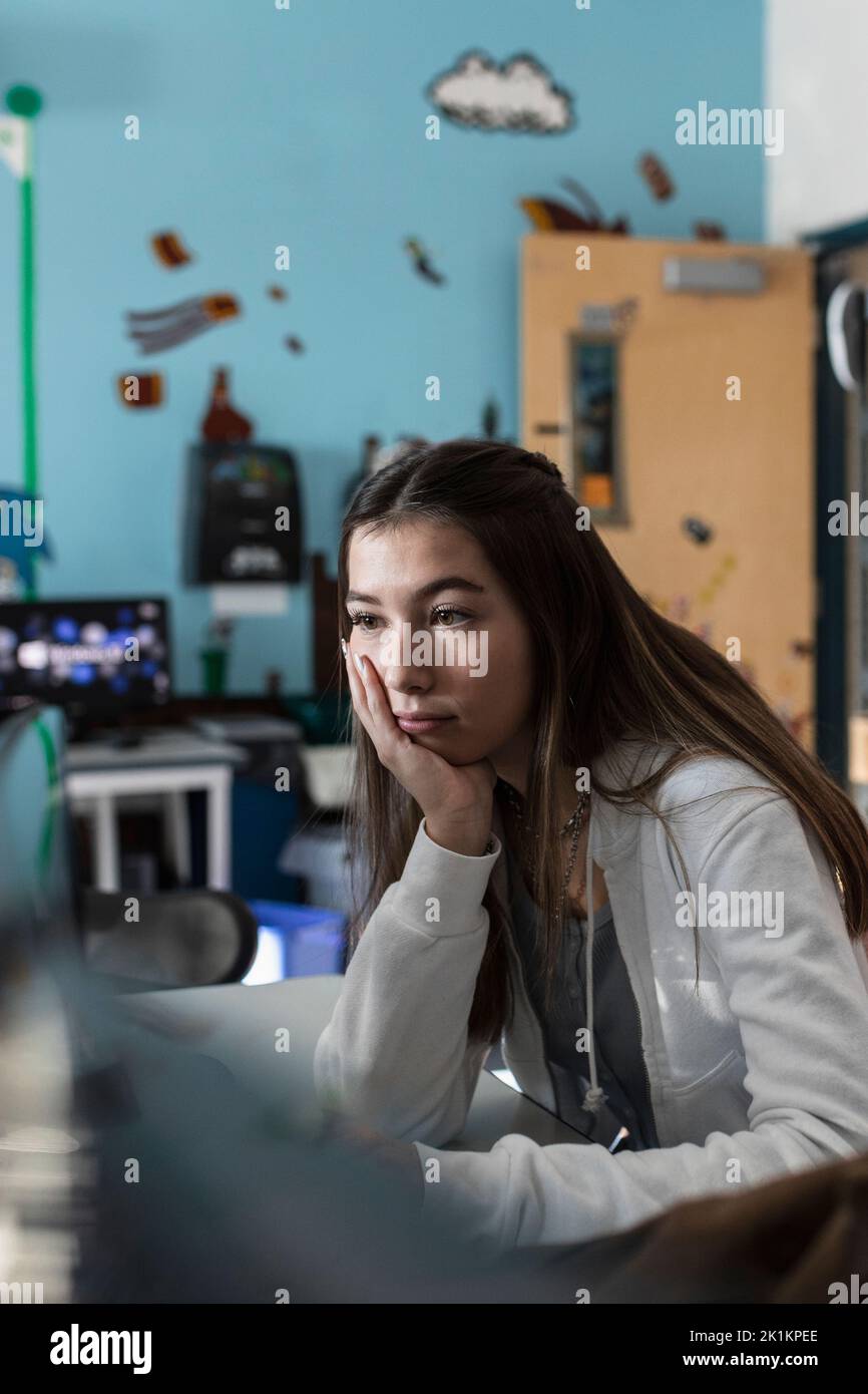 Focused high school girl student studying in classroom after school Stock Photo