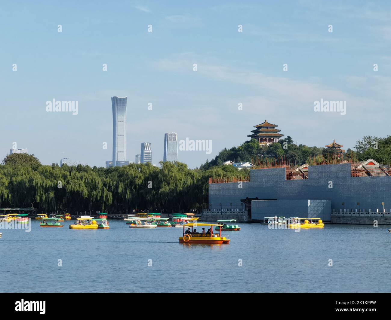 The cruise boats in Beihai Park with ancient and modern buildings of Beijing in the background Stock Photo