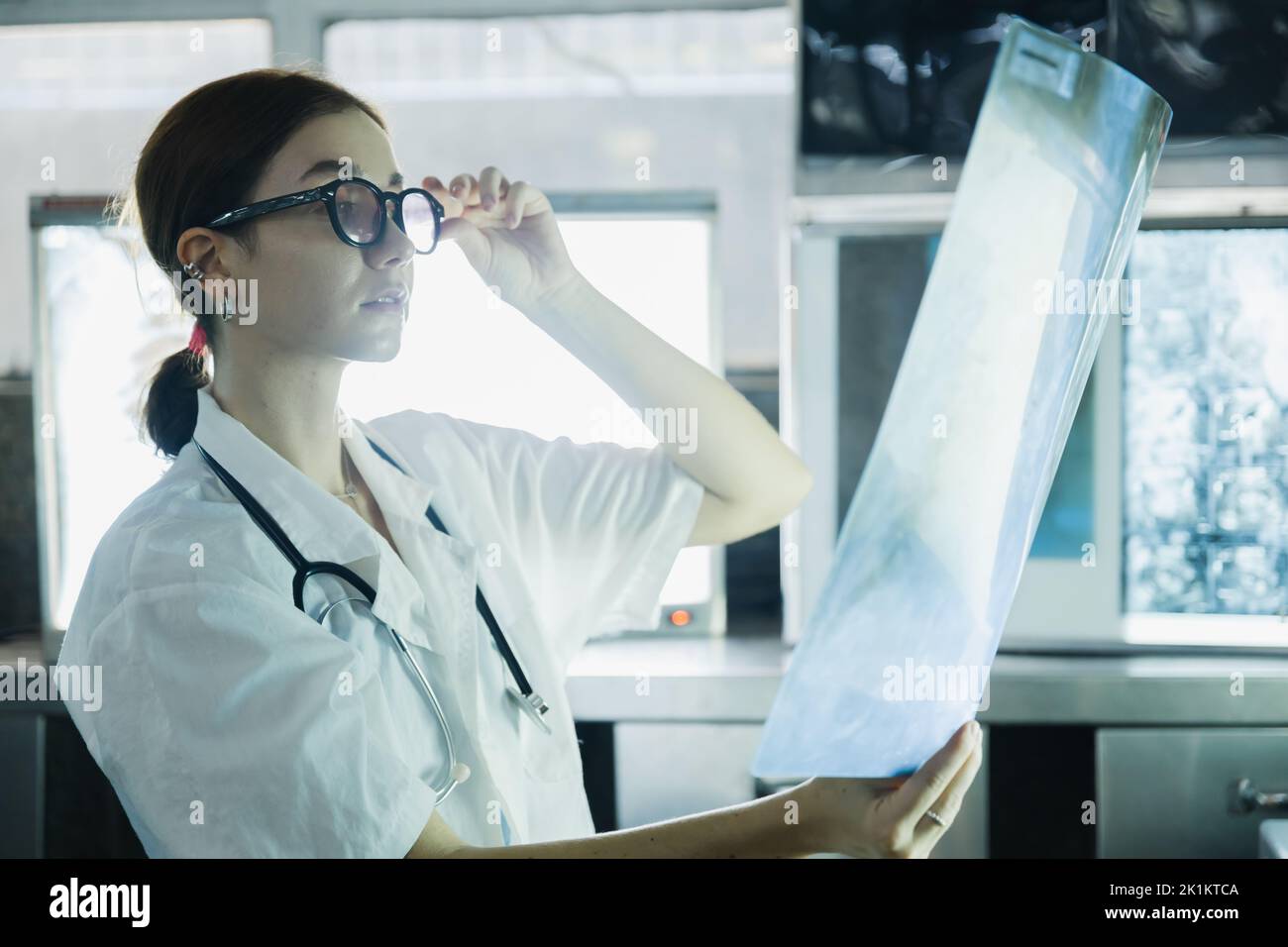 Female doctor check on scan results on monitors in laboratory Stock Photo