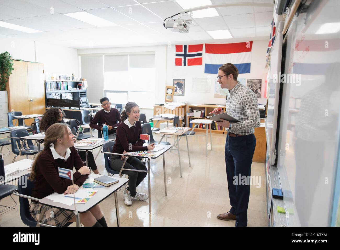 High school teacher and students talking in geography class Stock Photo