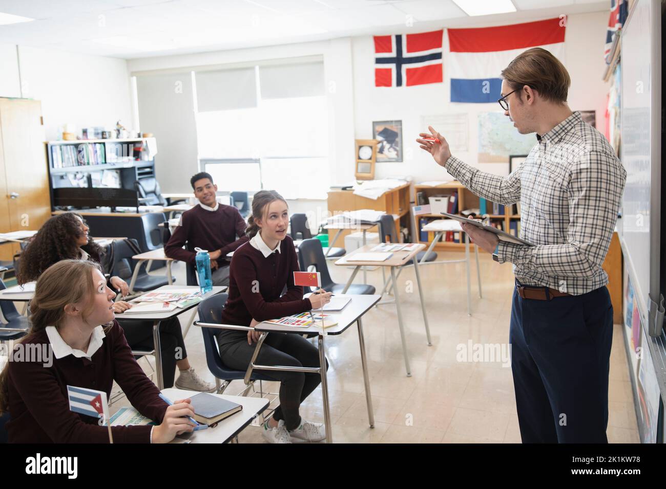 High school teacher and students talking in geography class Stock Photo