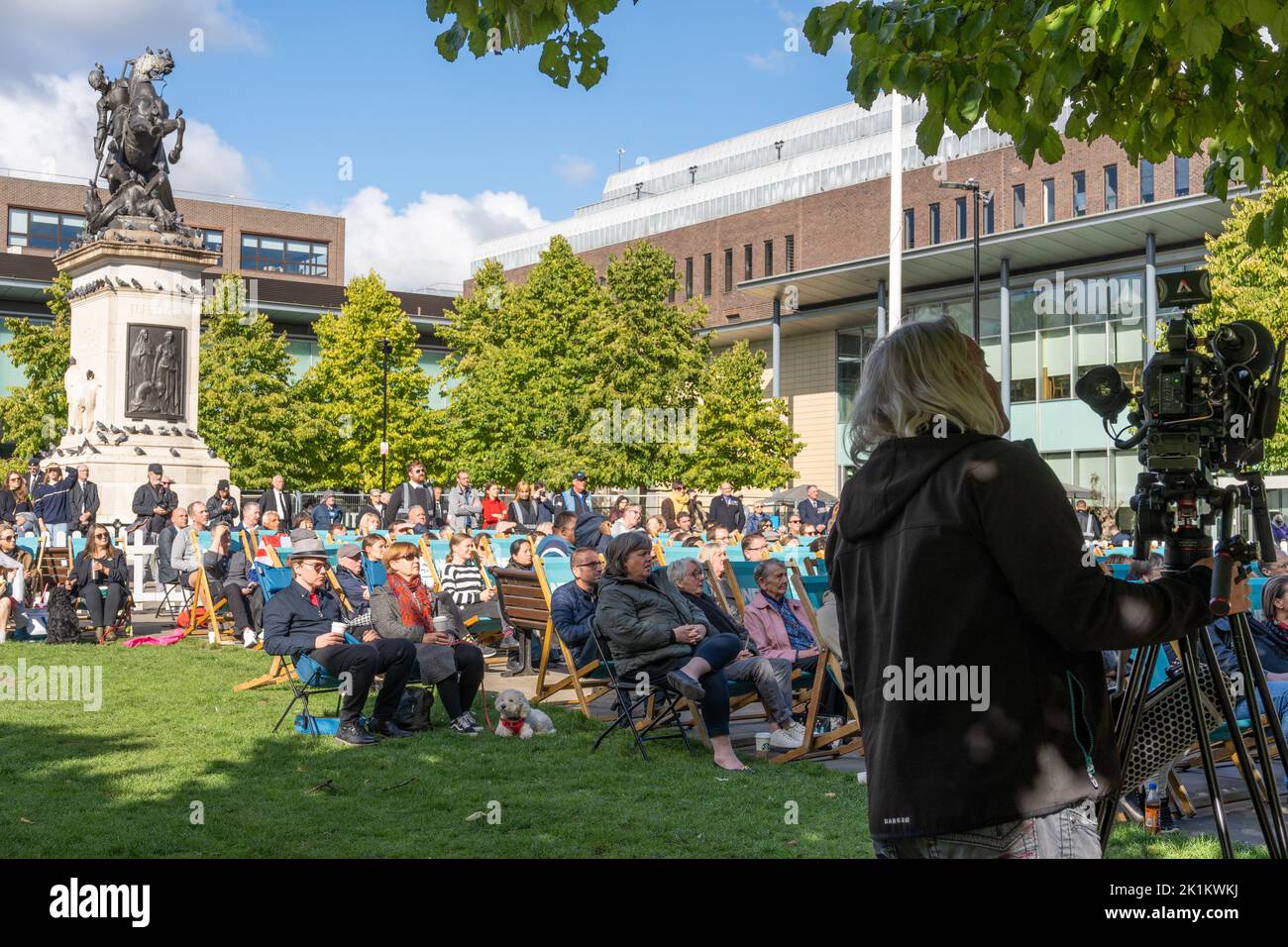 Newcastle upon Tyne, UK. 19th September 2022. People gather to watch the funeral of Queen Elizabeth II on a big screen in Old Eldon Square. Credit: Hazel Plater/Alamy Live News Stock Photo