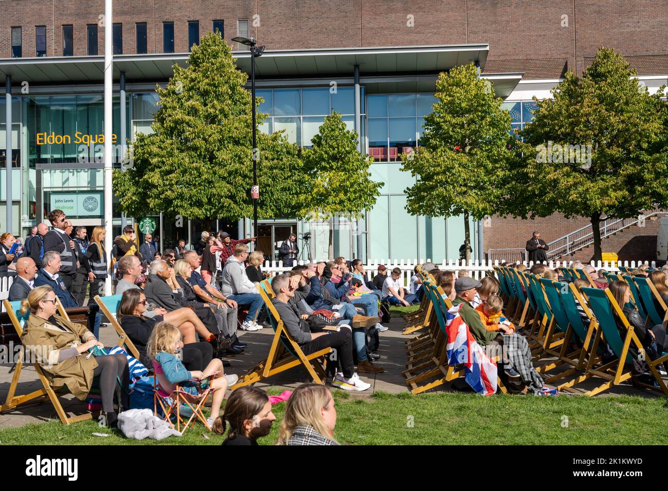 Newcastle upon Tyne, UK. 19th September 2022. People gather to watch the funeral of Queen Elizabeth II on a big screen in Old Eldon Square. Credit: Hazel Plater/Alamy Live News Stock Photo