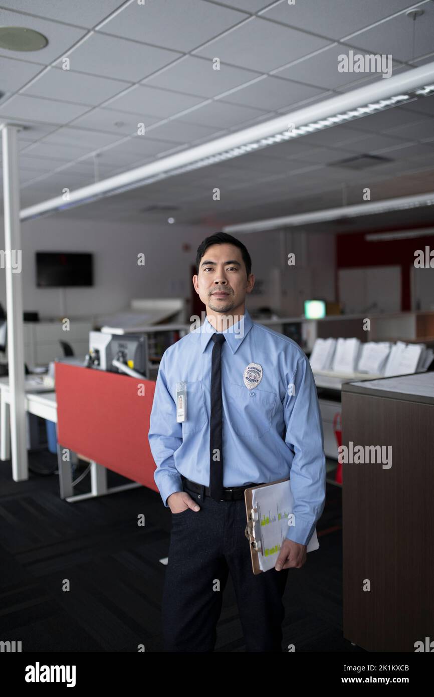 Portrait of security guard wearing badge looking away Stock Photo Alamy