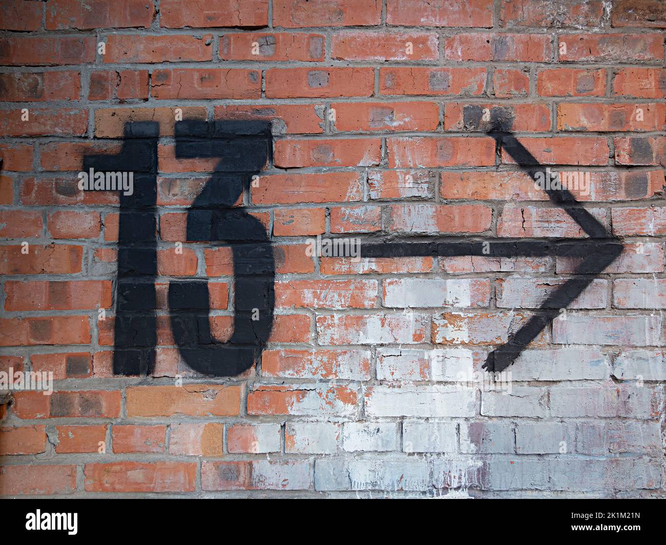 Number 13 thirteen arrow sign on the brick wall Stock Photo Alamy