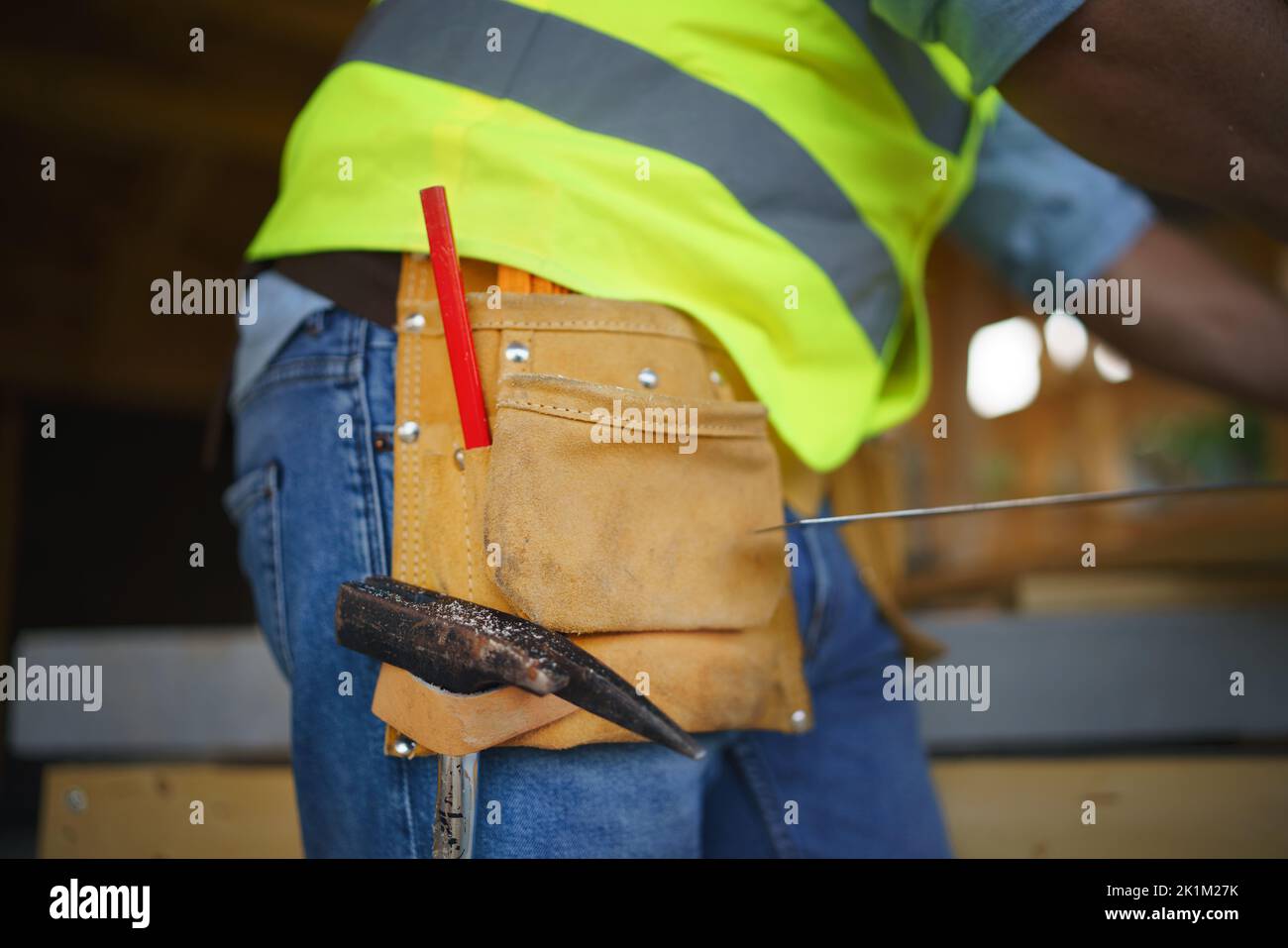 Closeup of mid section construction worker in protective clothes and