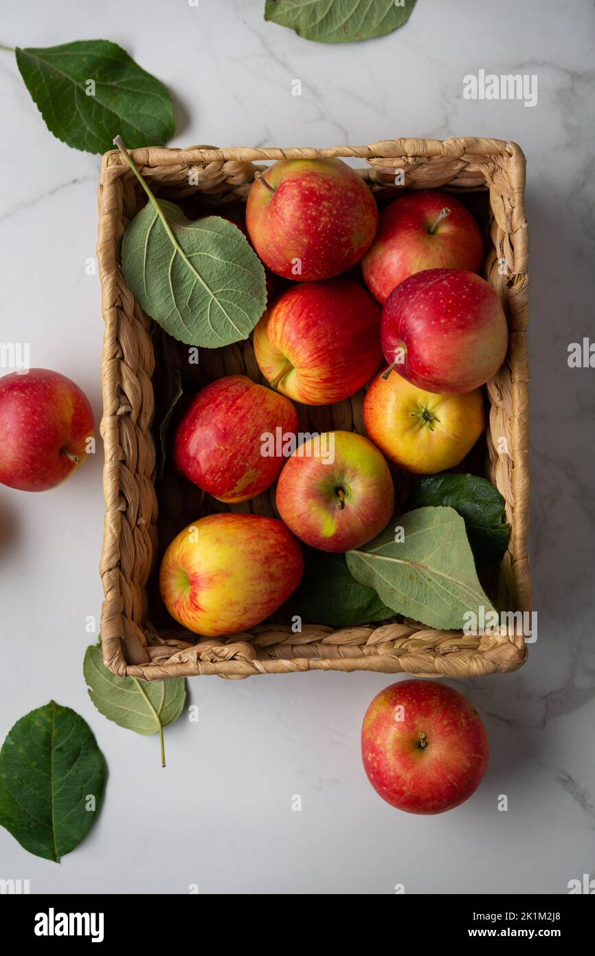 Few red apples in crate on light surface food Stock Photo