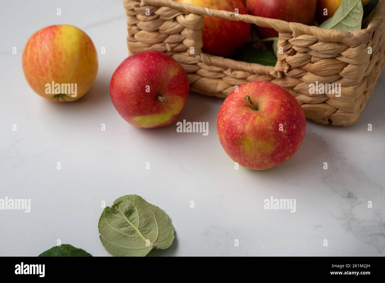 Few red apples in crate on light surface food harvest concept Stock Photo
